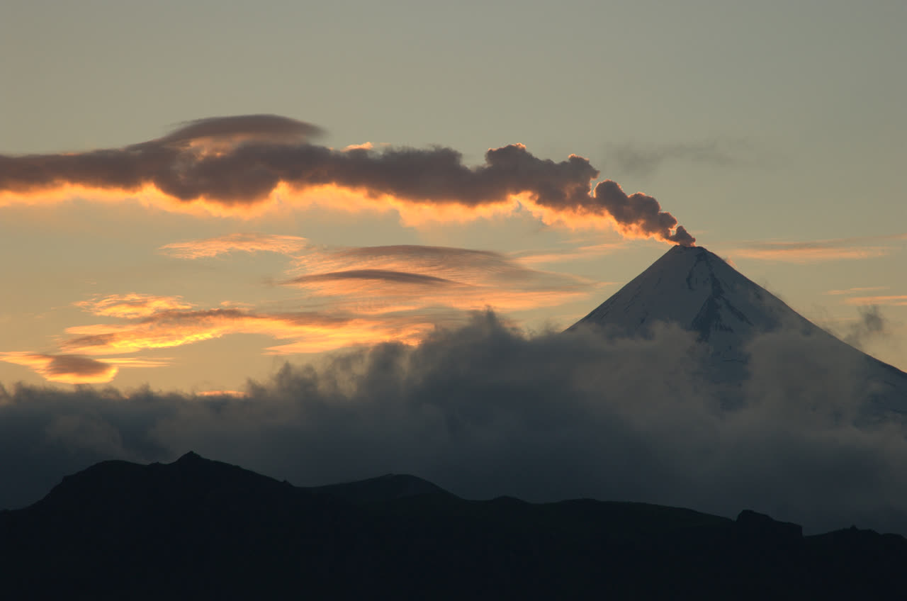 Archive reference photo of Shishaldin Volcano at sunset; not current conditions.